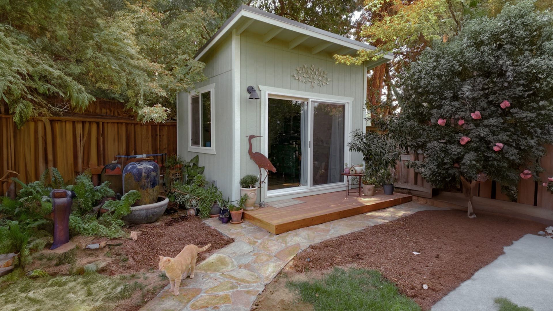 Green lean-to shed in backyard