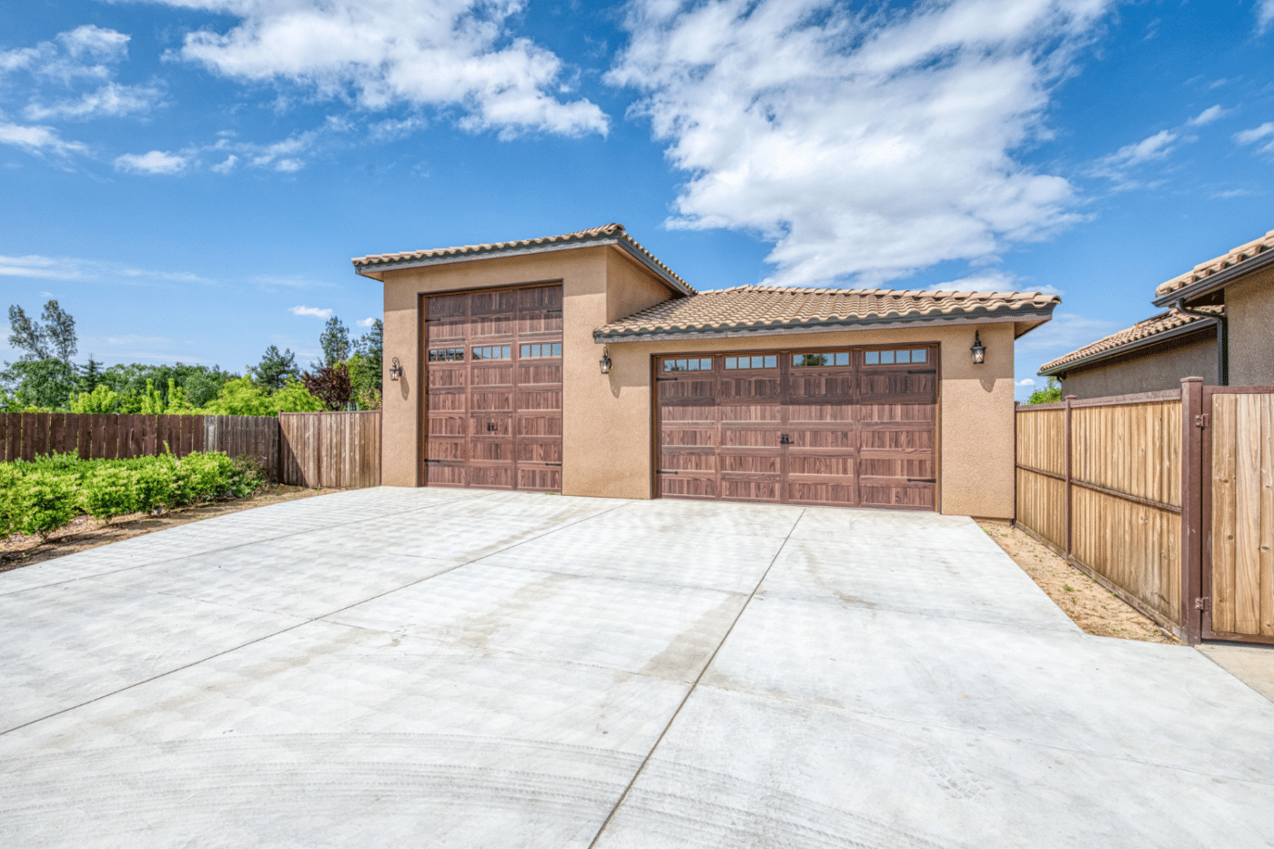 beige three car garage with brown doors in dunlap ca