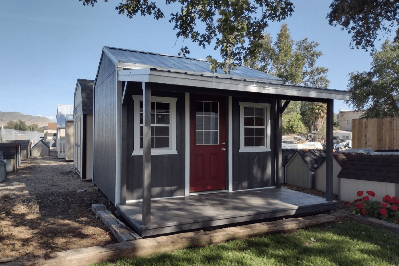 blue custom cottage shed with red door in dunlap ca