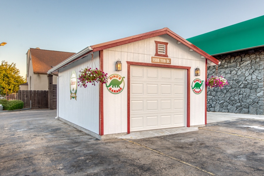 custon white and red trimmed one car garage built in accordance with garage setback requirements in California