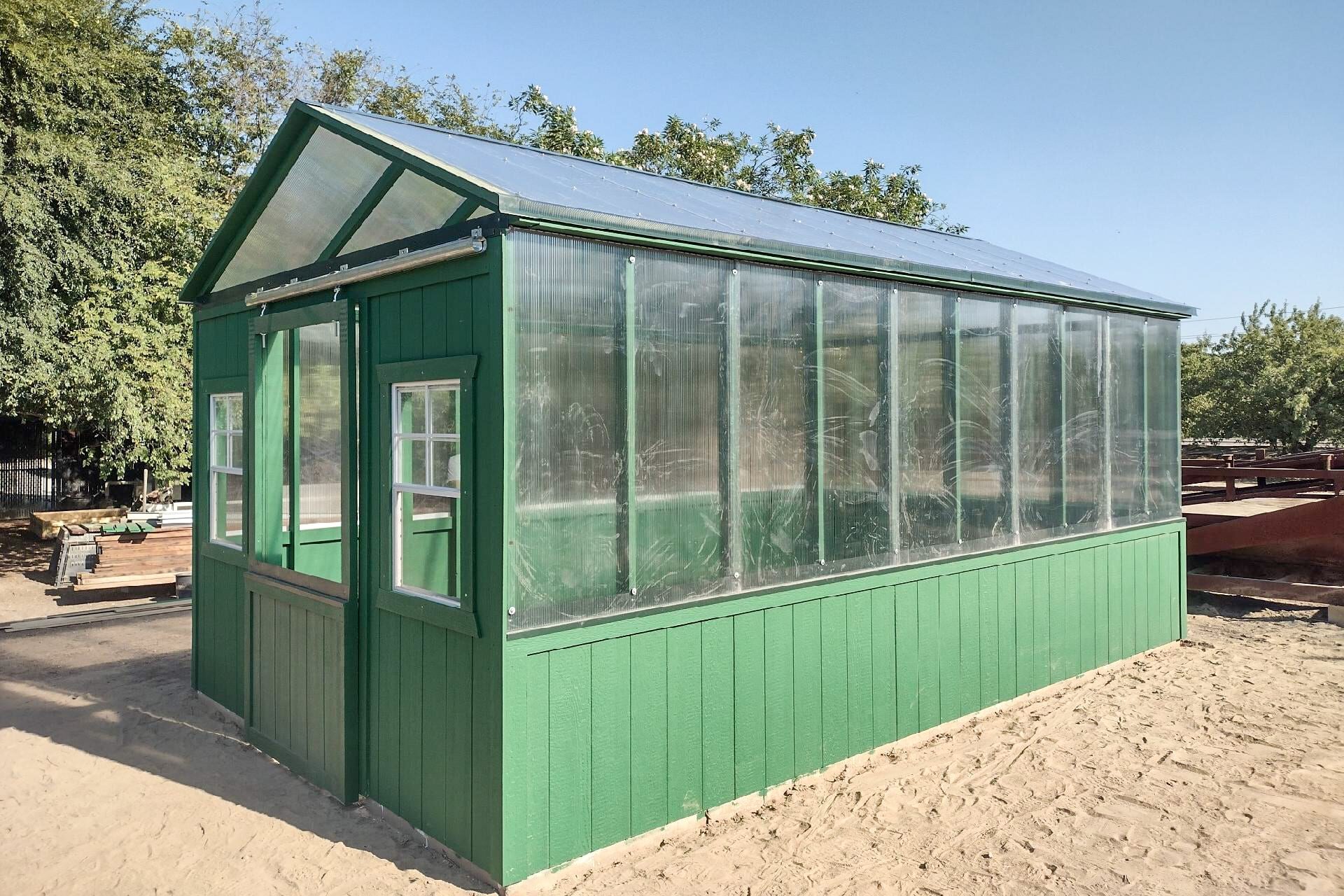 green and clear sided greenhouse shed in California