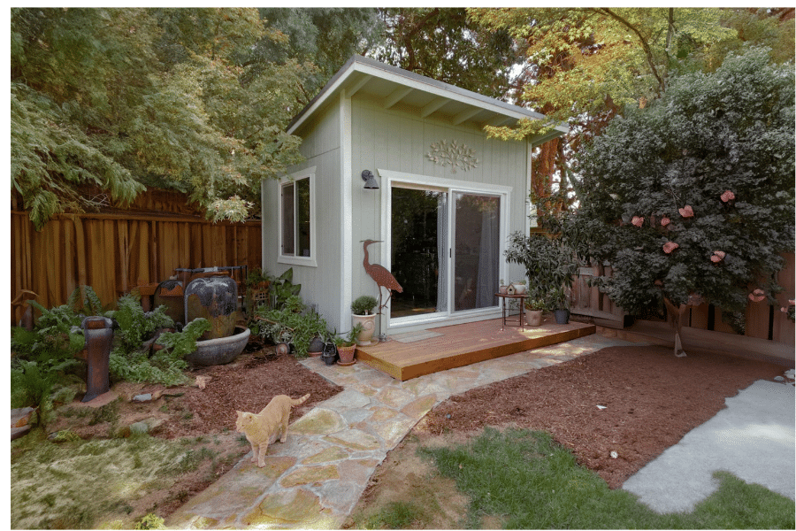 green lean to shed with slider doors and front porch