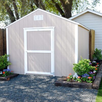 tan and white trimmed value rancher with garden bed around it