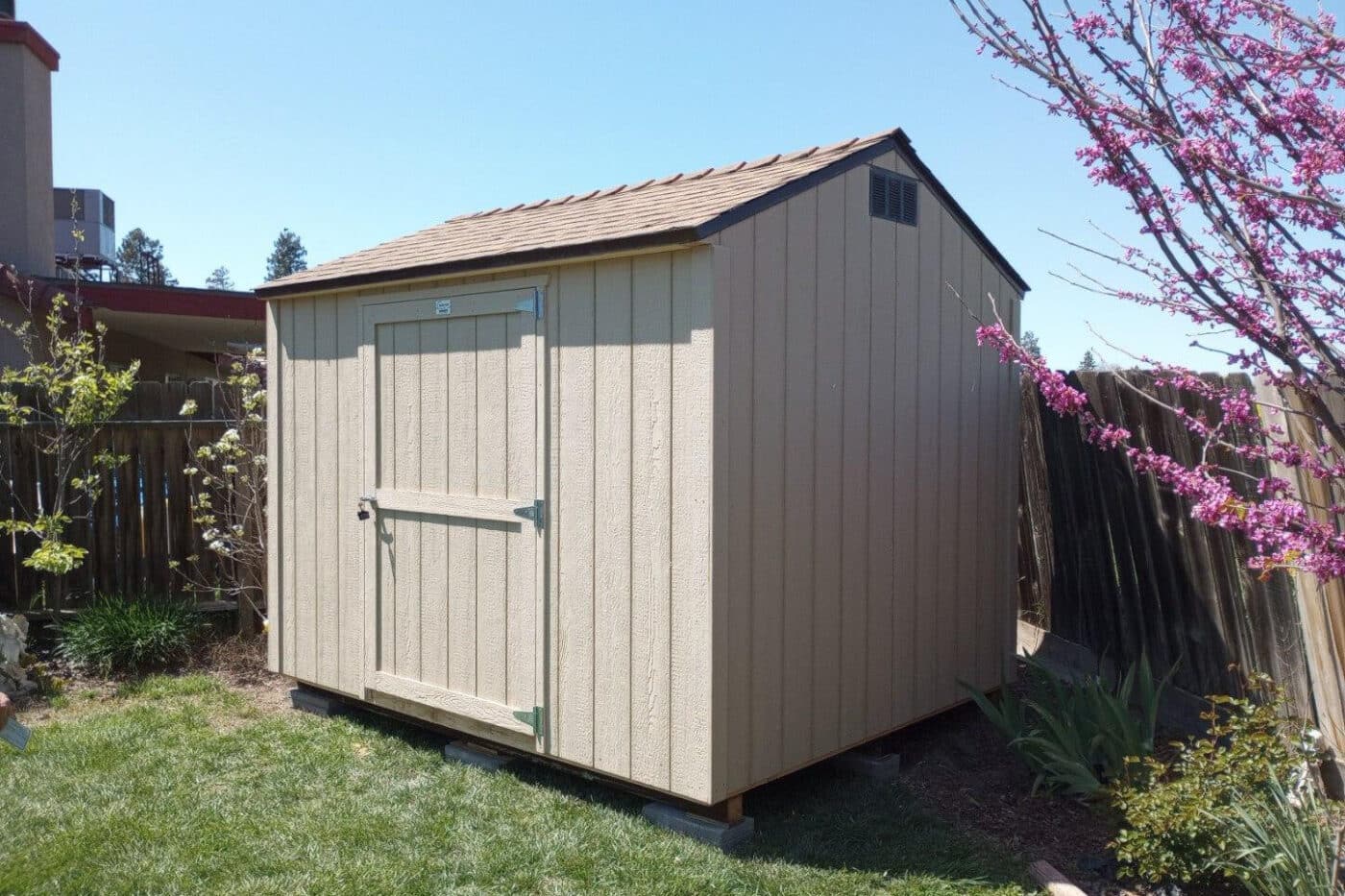 tan sided shed along back fence in California backyard